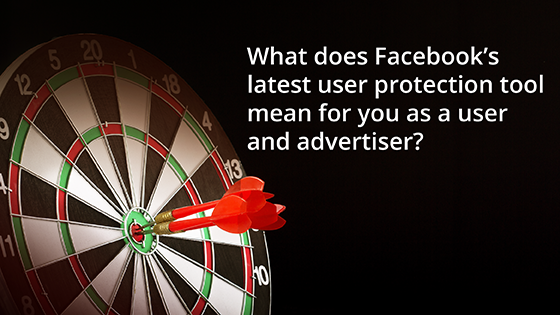 A dart board with three red darts in the center on a black background depicting targeted advertising